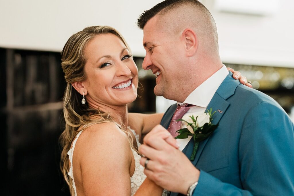Bride and groom laughing closely together during their first dance at a New Jersey wedding reception