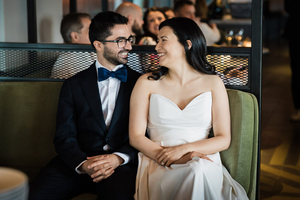 Newlyweds sharing a relaxed, unposed moment during their NYC wedding