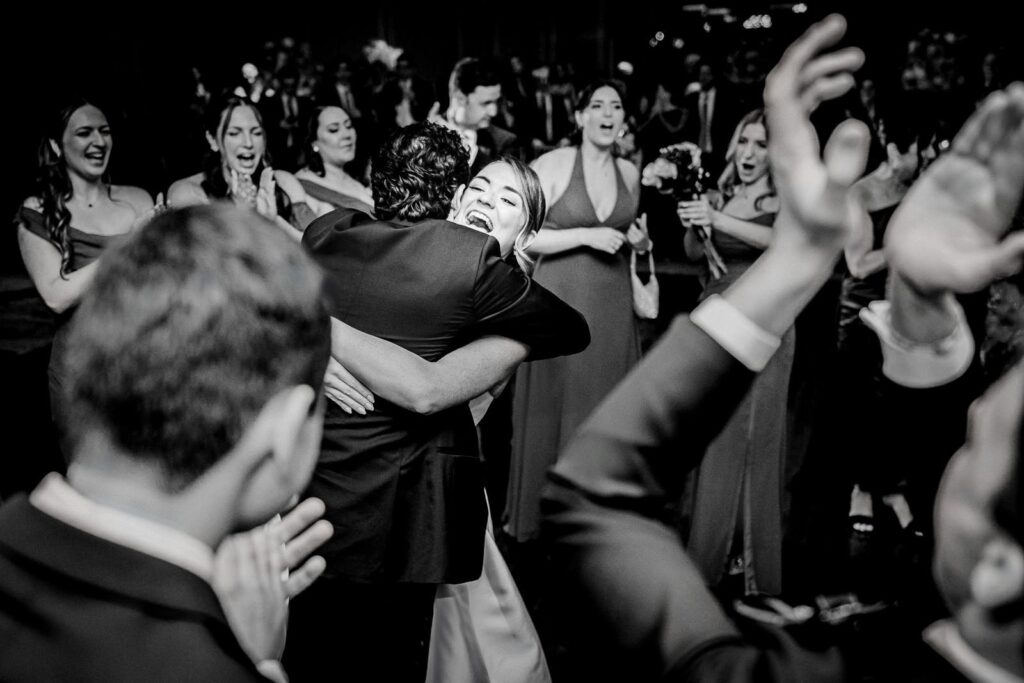 Bride embracing a guest mid-celebration at a Westin Governor Morris wedding in Morristown NJ