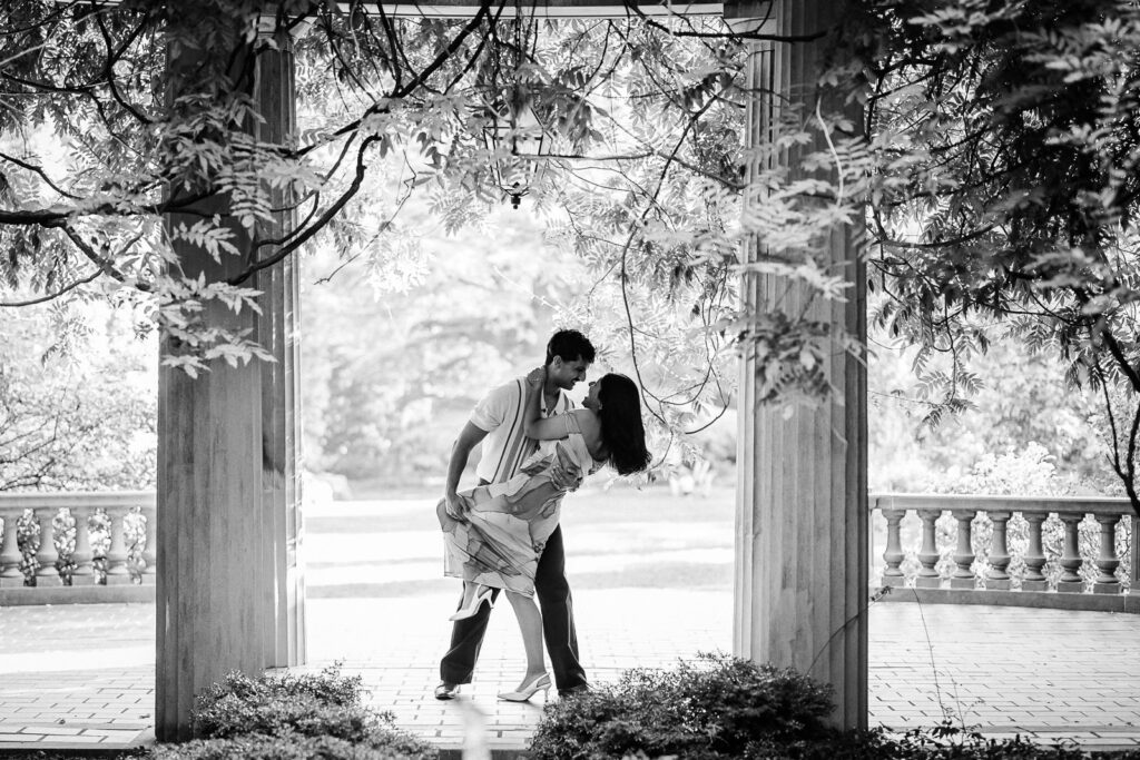 Engaged couple sharing a dip pose under the portico at Van Vleck Gardens in Montclair NJ