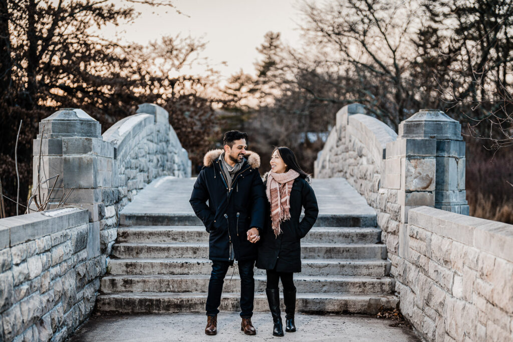 Engaged couple laughing together during an engagement session at Verona Park in New Jersey