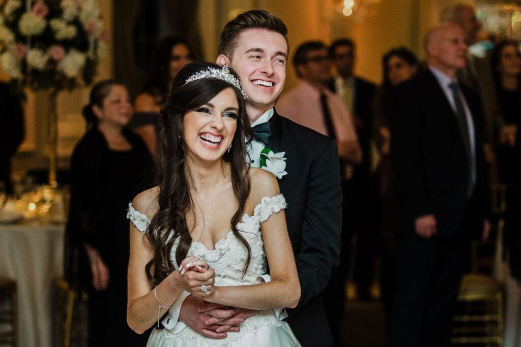 Newlyweds laughing together in a natural unposed moment at The Rockleigh wedding in New Jersey