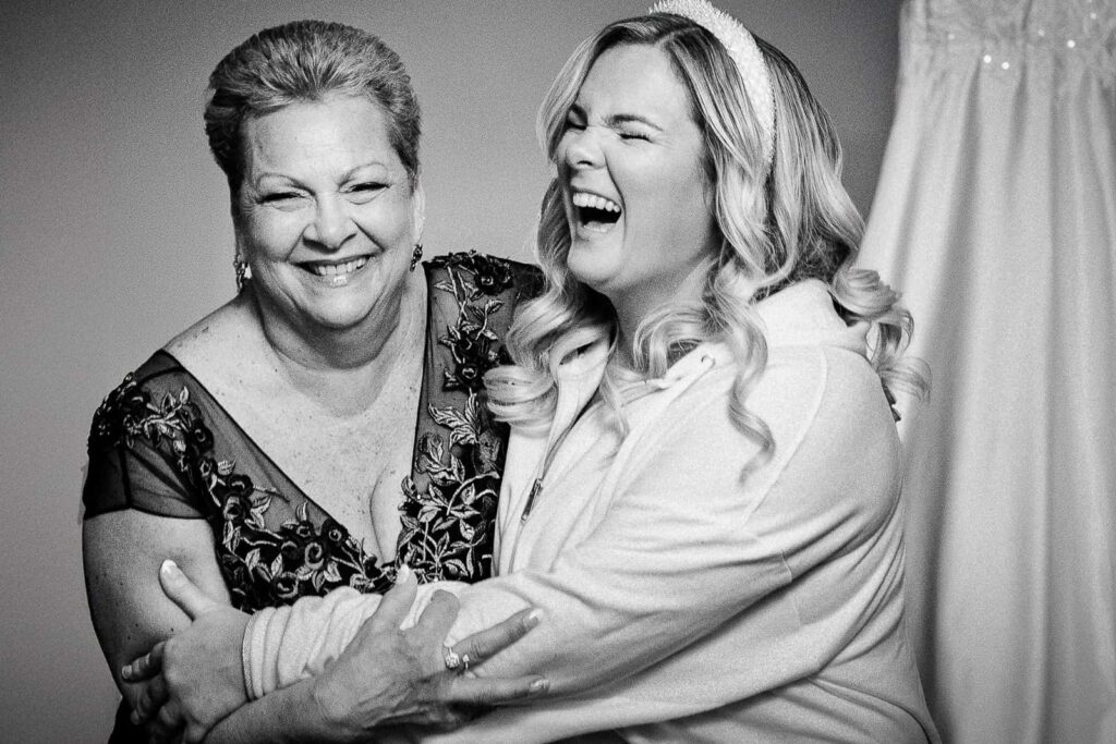 Bride laughing with her mother during getting ready, candid Northern New Jersey wedding photography