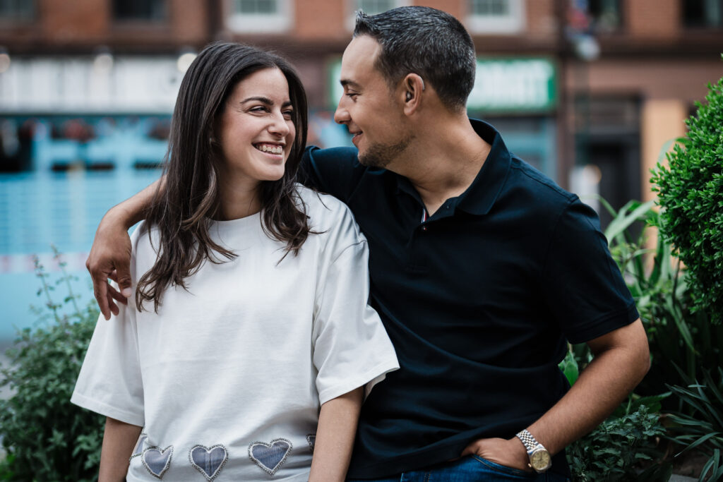 Couple sharing a natural glance between poses during their New York City engagement session