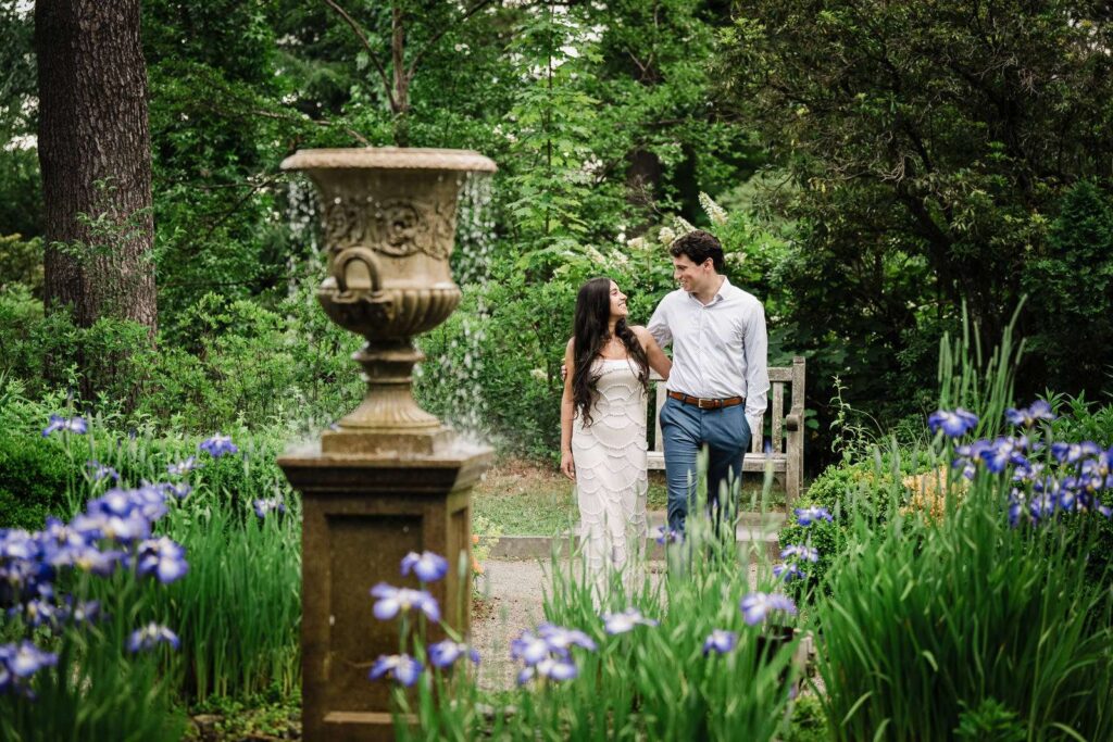 Engaged couple walking through the iris gardens at Van Vleck House in New Jersey