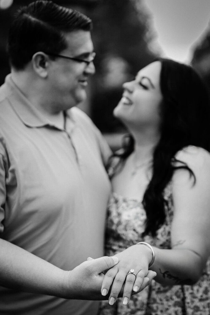 Engaged couple sharing a close, tender moment in black and white at Skylands Manor