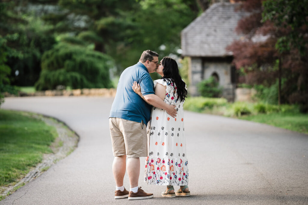 Engaged couple kissing on a quiet road during a Skylands Manor engagement session in Ringwood NJ