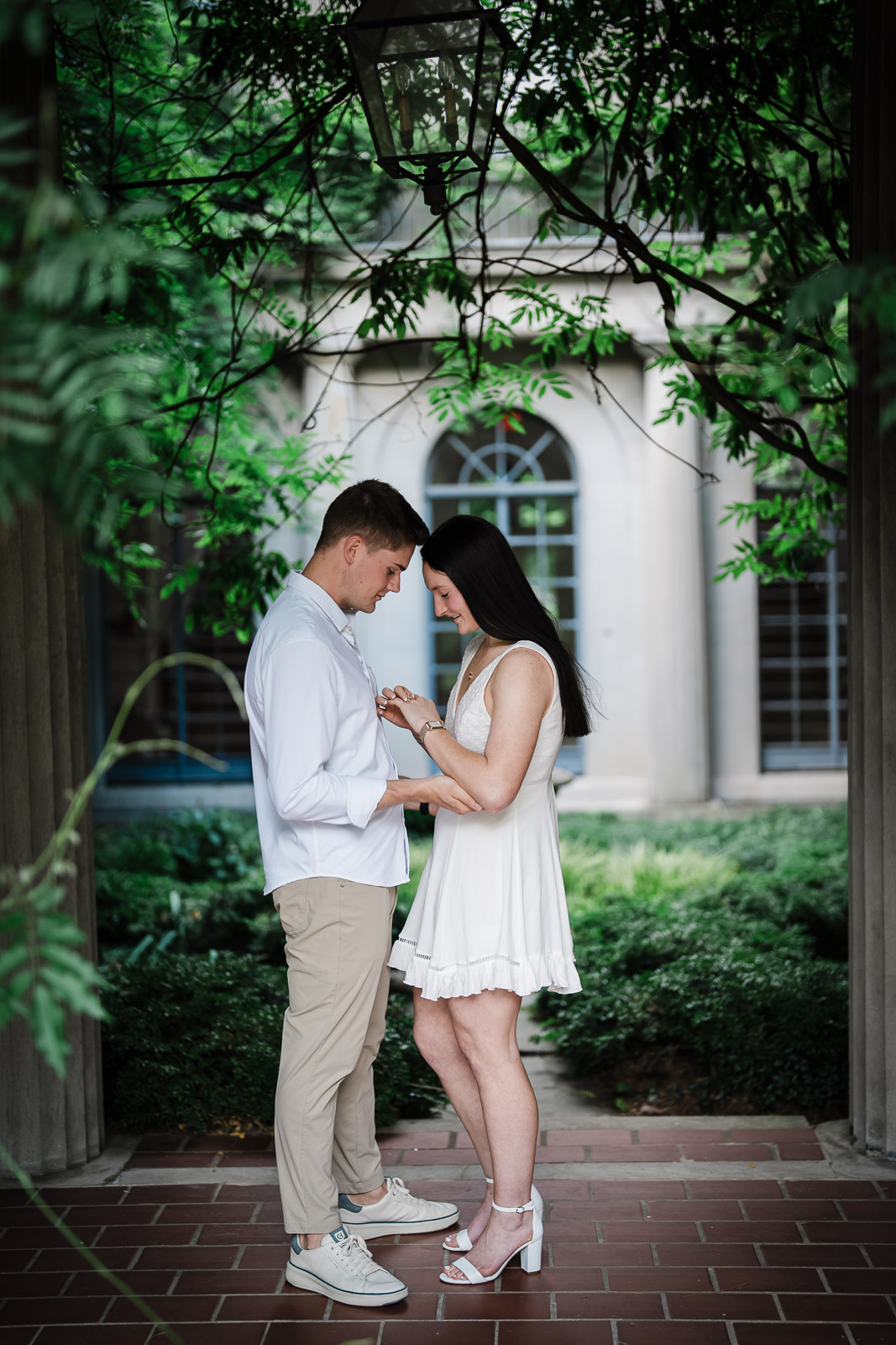 Couple admiring the new engagement ring outside the historic Van Vleck House in Montclair