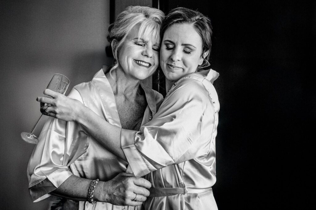 Bride and her mother sharing an emotional hug before the ceremony in New Jersey