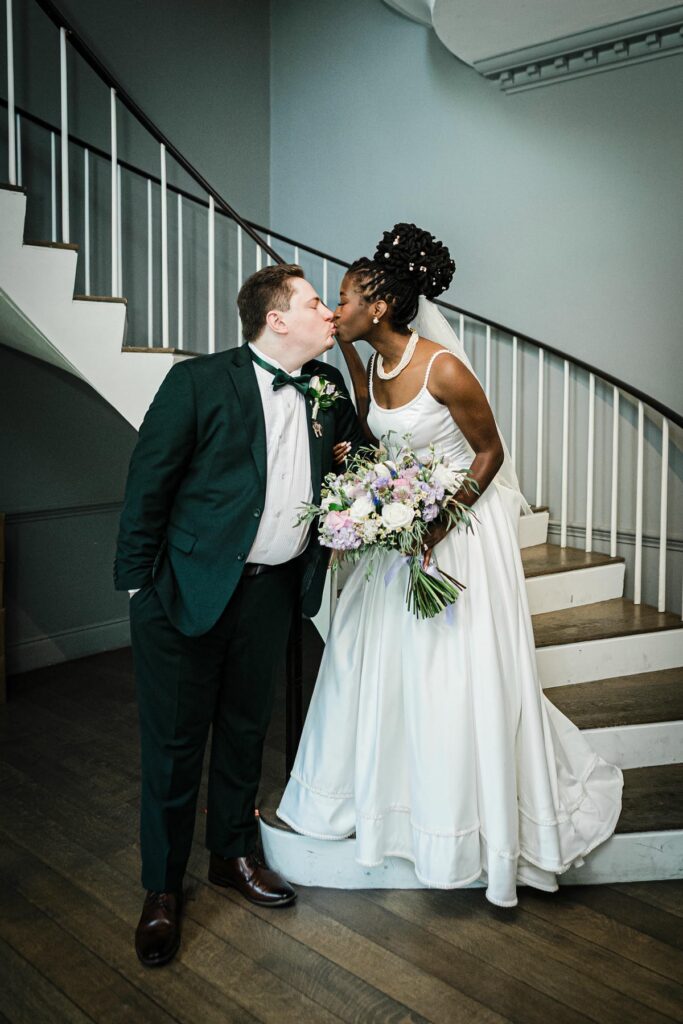 Bride and groom portrait on the staircase inside Alverthorpe Manor