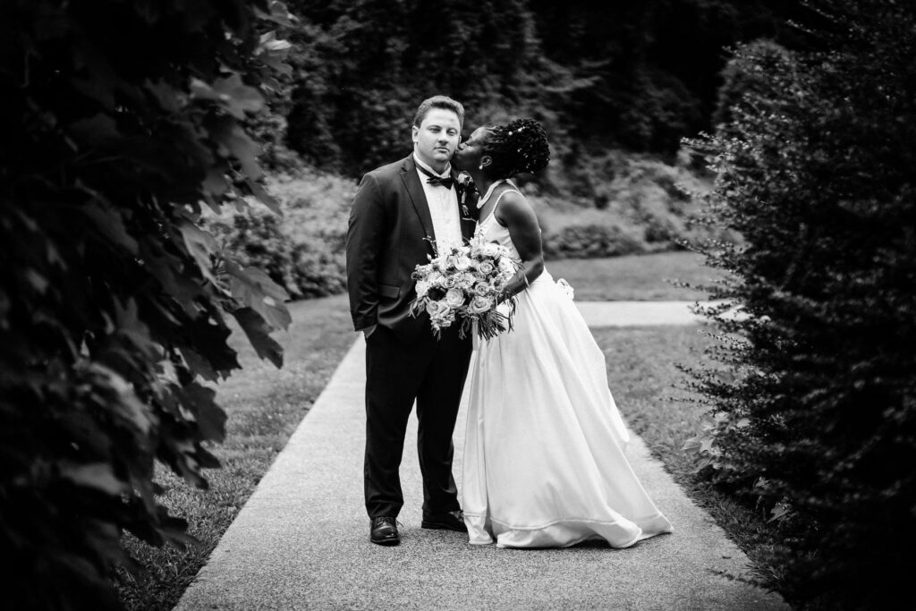 Black and white bride and groom portrait in the Abington Art Center gardens