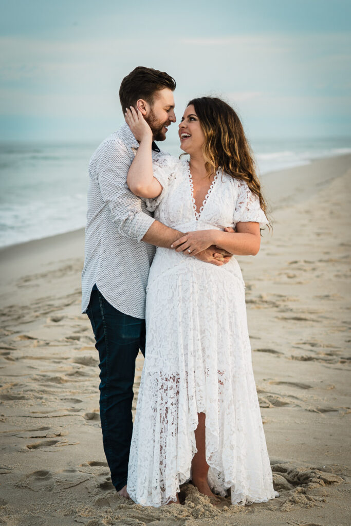 Couple laughing together during a New Jersey beach engagement session