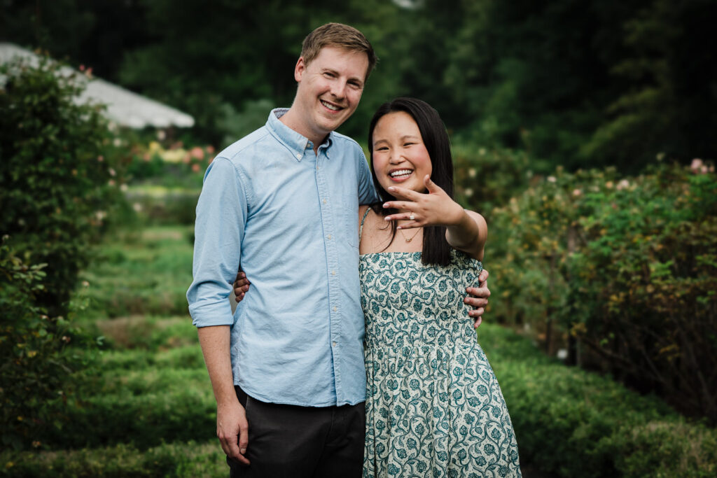 Newly engaged couple showing the ring in the rose garden at Deep Cut Gardens NJ