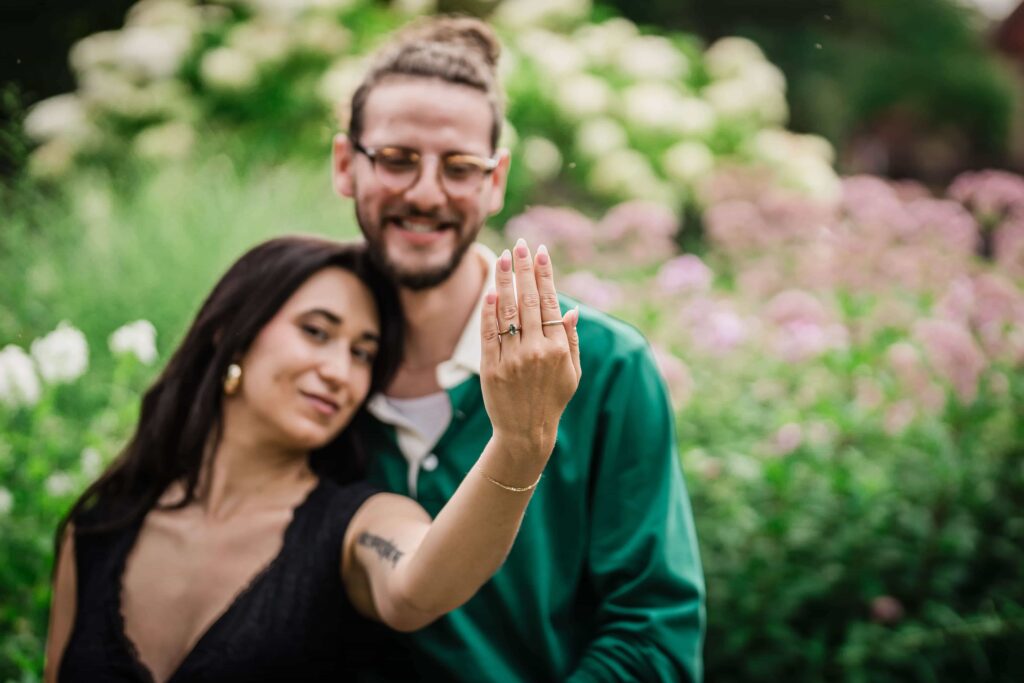 Lexi showing her engagement ring after the garden proposal at Van Vleck Gardens Montclair