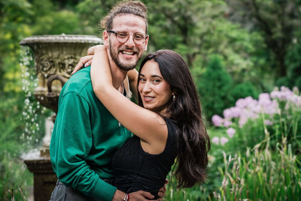 Philip and Lexi embracing by the fountain with no decorations at Van Vleck Montclair