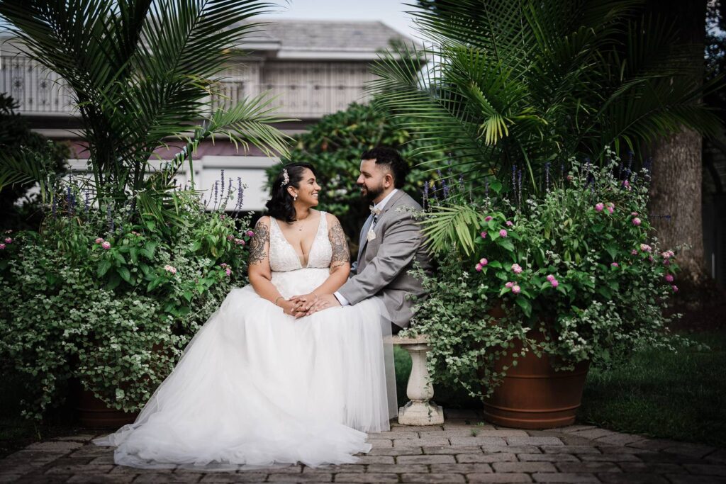 Couple sitting together in a garden during wedding portraits in Northern New Jersey