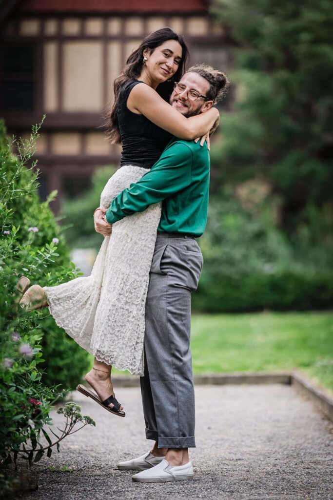 Philip lifting Lexi outside Van Vleck House in Montclair New Jersey after their proposal
