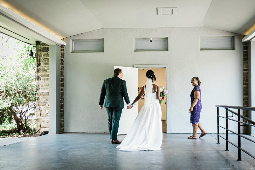 Newly married couple walking together after their Abington Art Center ceremony