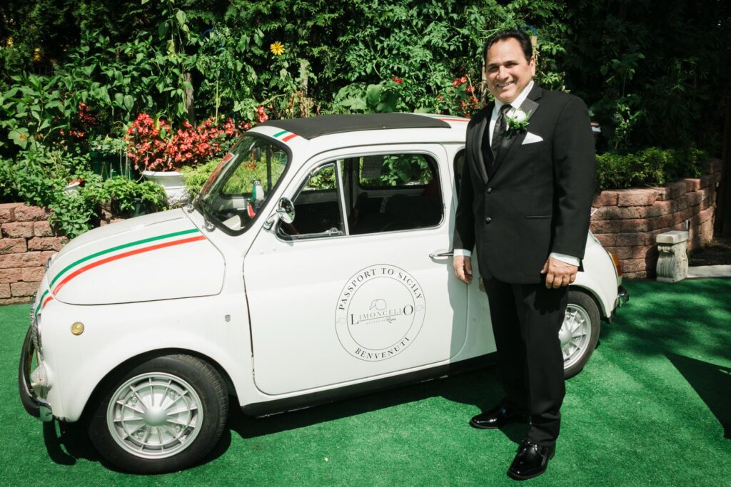 Bride and groom beside a vintage Italian Fiat at Piazza di Roma