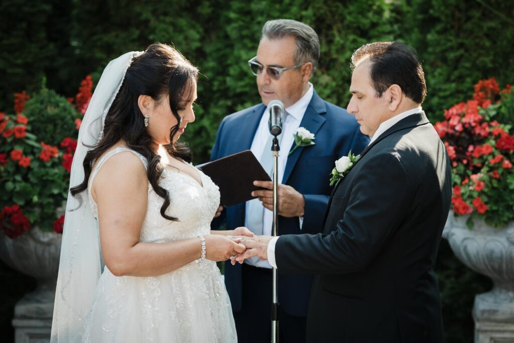 Bride and groom exchanging rings during their Piazza di Roma wedding ceremony