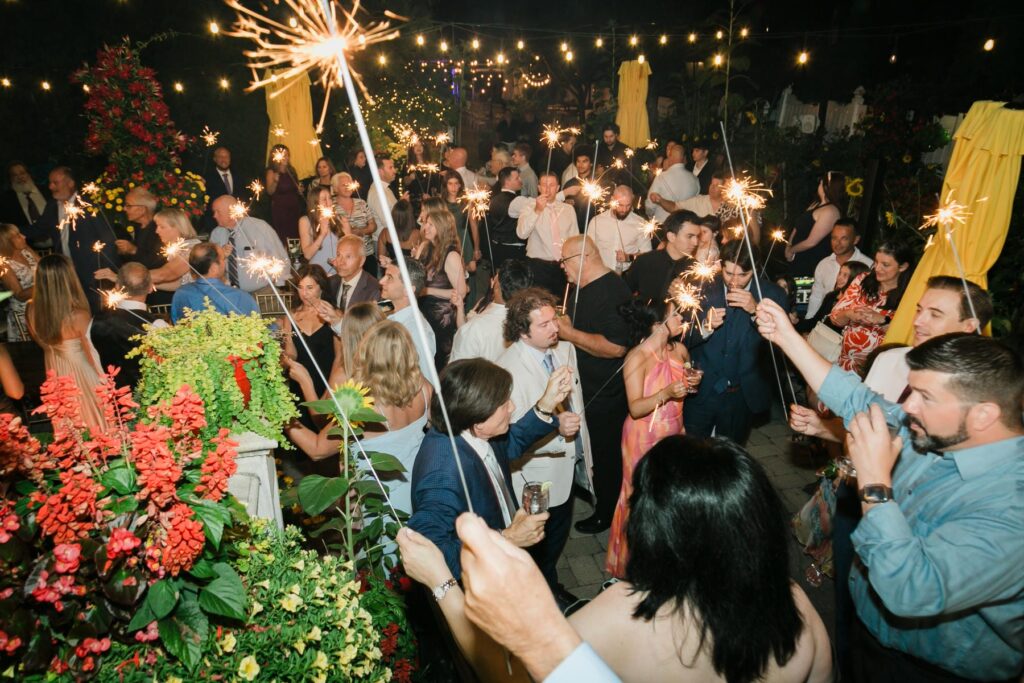 Guests holding sparklers as the couple exits their New Jersey wedding reception