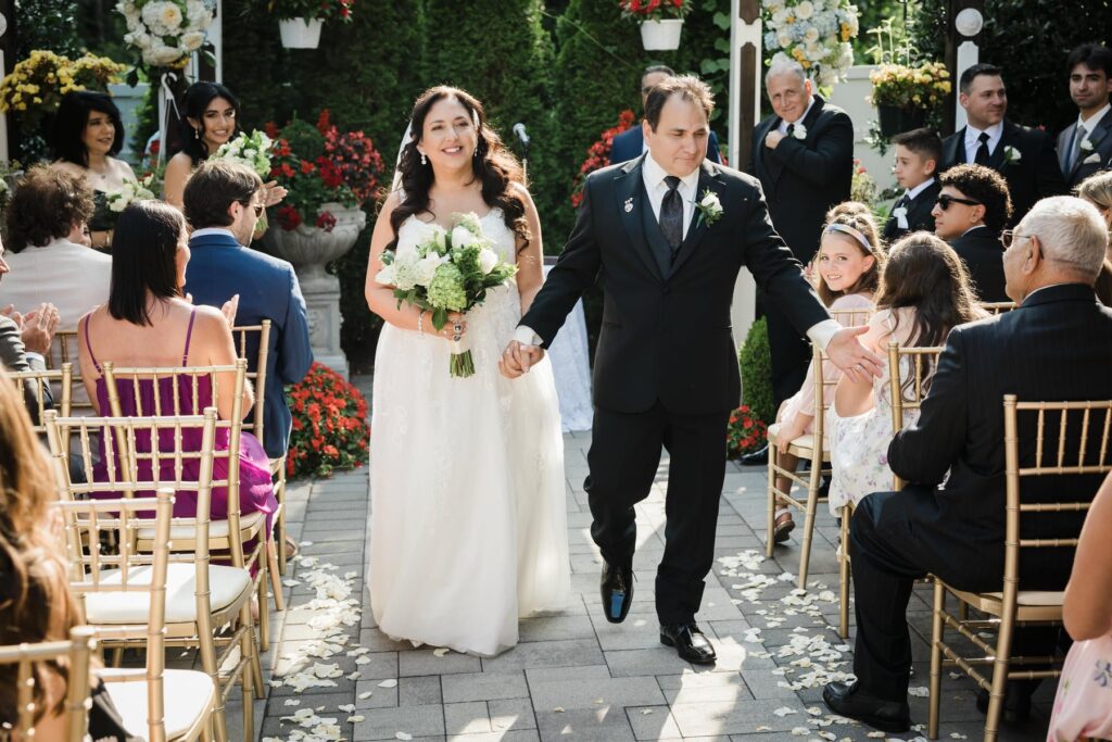 Newlyweds walking back up the aisle after their Aberdeen New Jersey ceremony