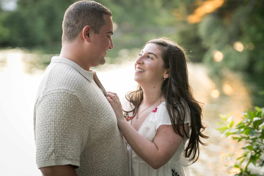 Couple angled toward the camera so the partner's reaction is visible during a New Jersey proposal
