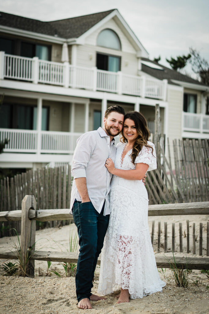 Engaged couple in coordinated light outfits at a Long Beach Island engagement session