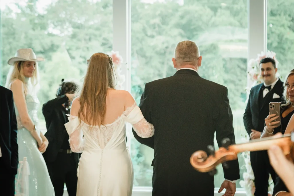 Bride walking down the aisle at her wedding ceremony at The Mill Lakeside Manor