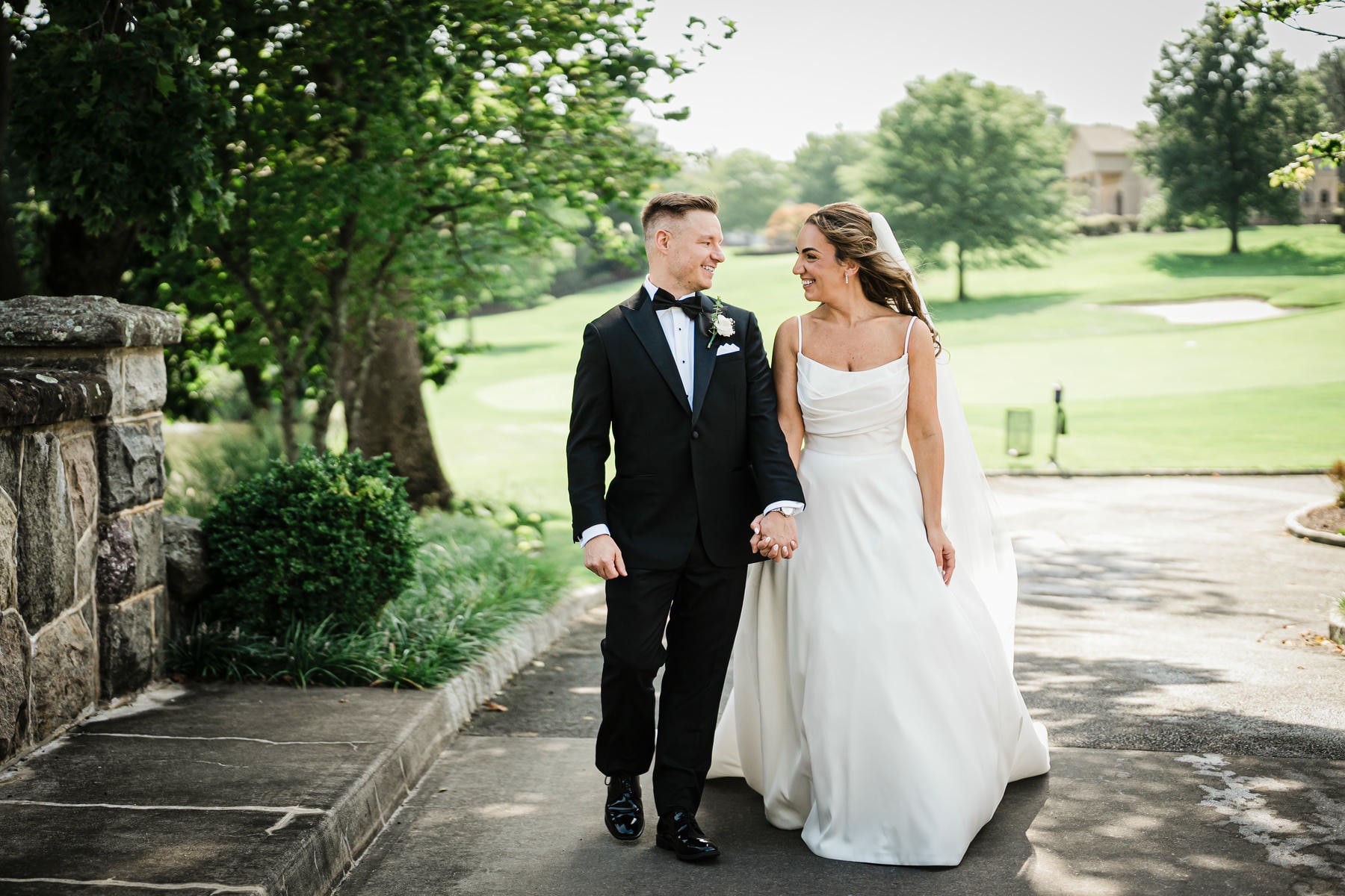 Ilysse and James standing together on the lawn at their Brooklake Country Club wedding