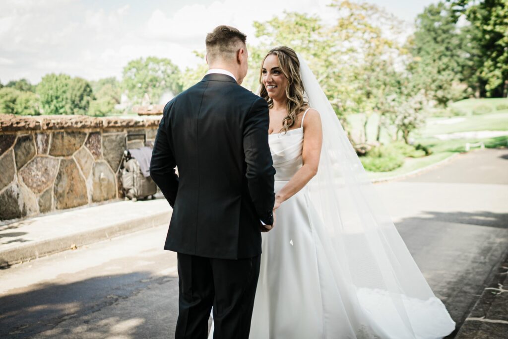 Ilysse and James on a tree lined pathway at Brooklake Country Club in Florham Park