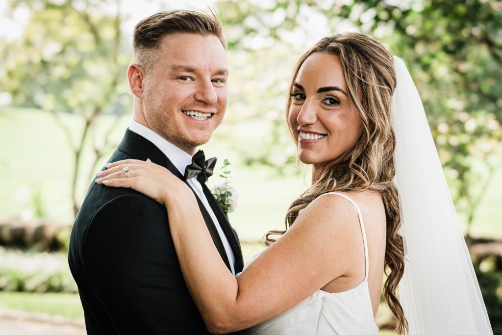 Ilysse and James laughing together during portraits at Brooklake Country Club