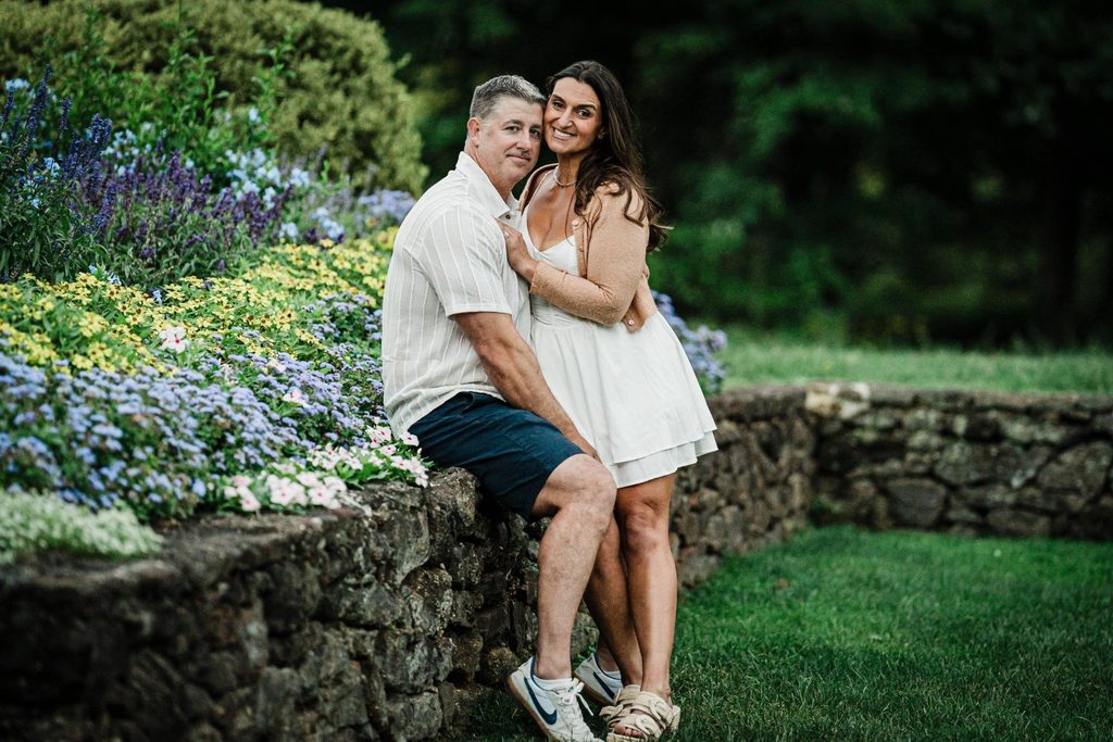 Couple wearing coordinated casual outfits for engagement photos at Deep Cut Gardens