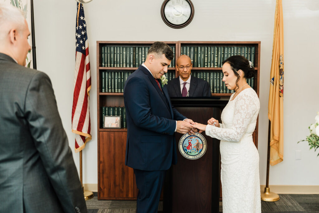 Couple exchanging rings during a civil ceremony at the Bergen County courthouse in Hackensack NJ