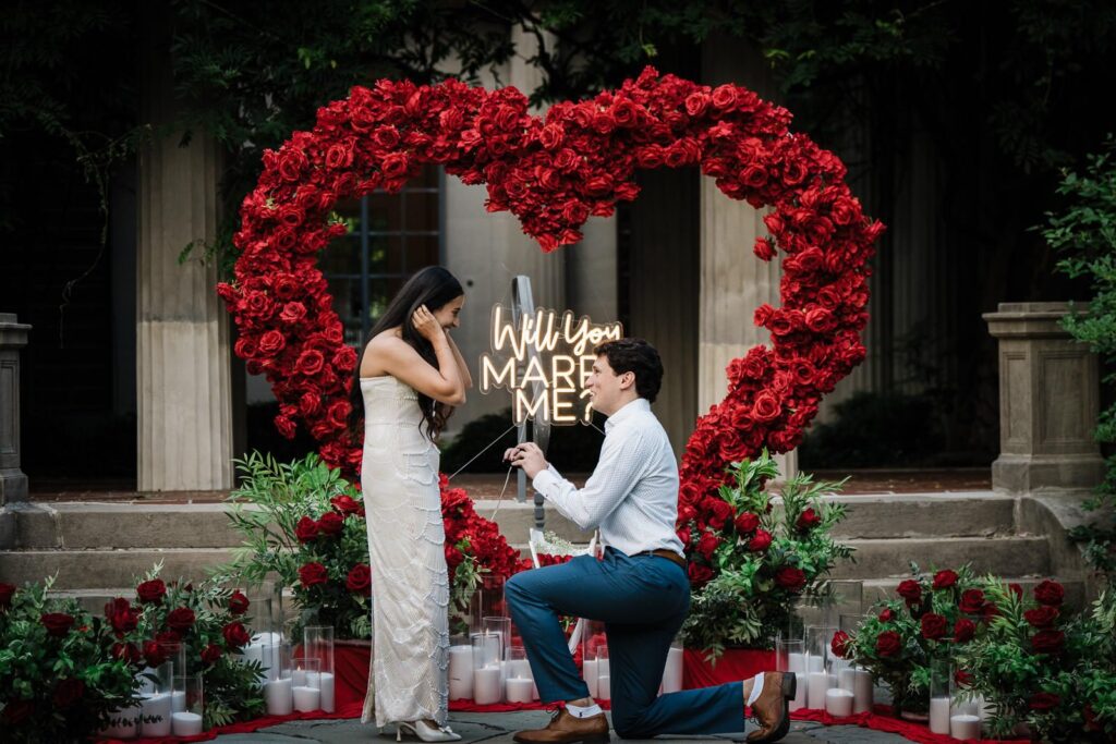 Couple at a custom red rose heart proposal installation at a Northern New Jersey estate