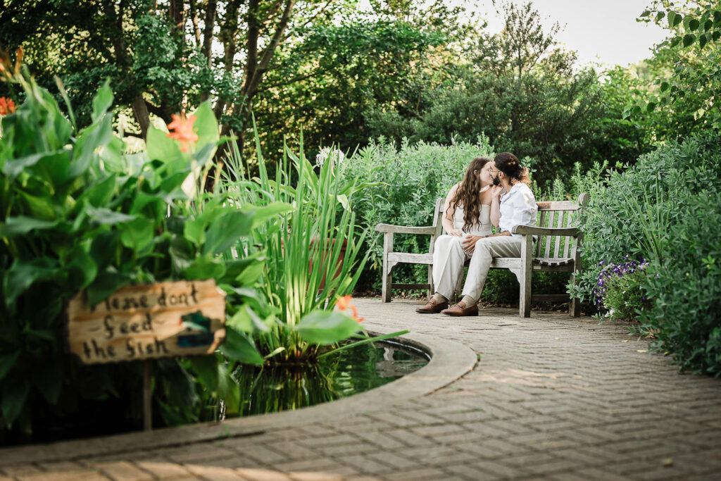 Engaged couple resting on a garden bench at Deep Cut Gardens in Monmouth County NJ