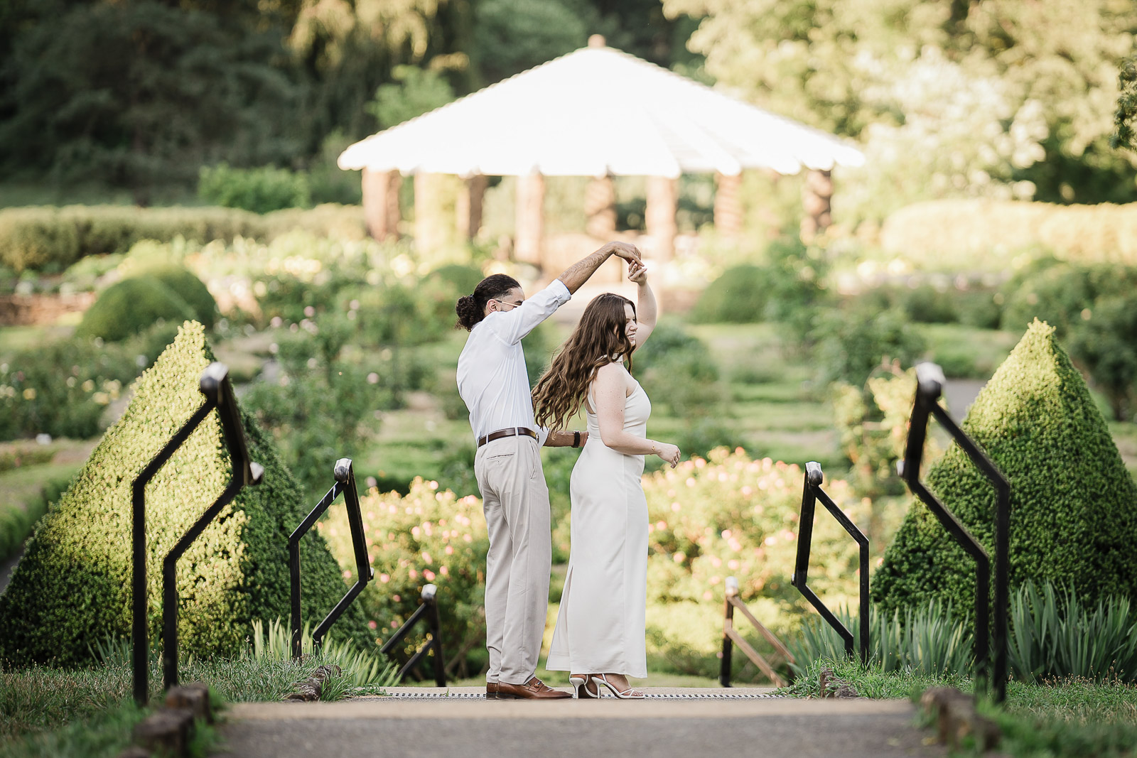 Couple wearing coordinated outfits during engagement session at Deep Cut Gardens