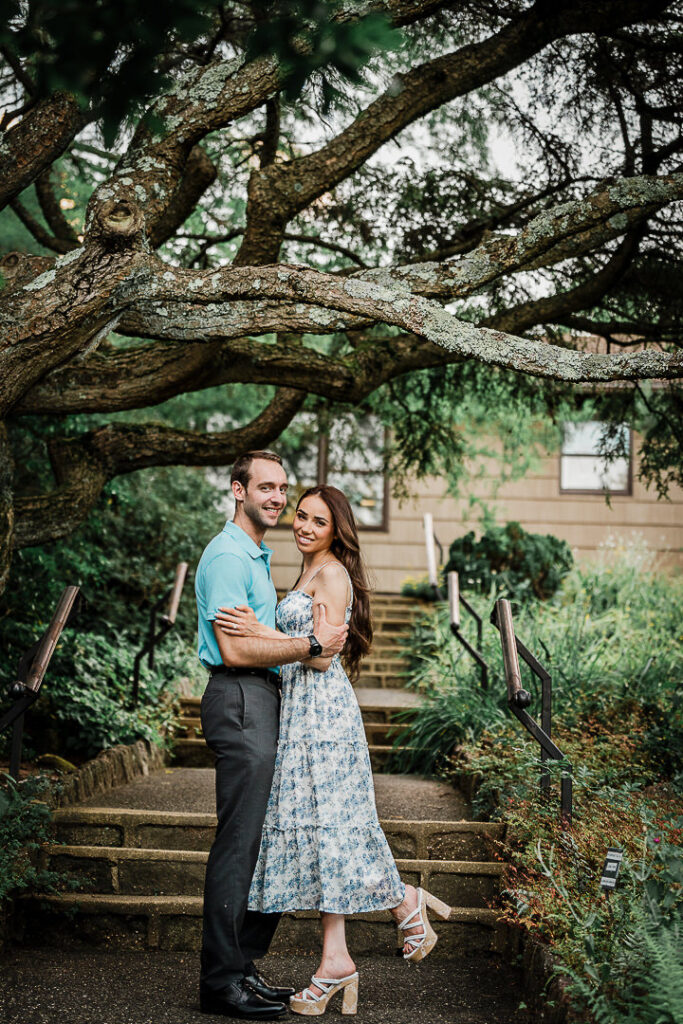 Couple under a sprawling tree in late afternoon light at Deep Cut Gardens NJ