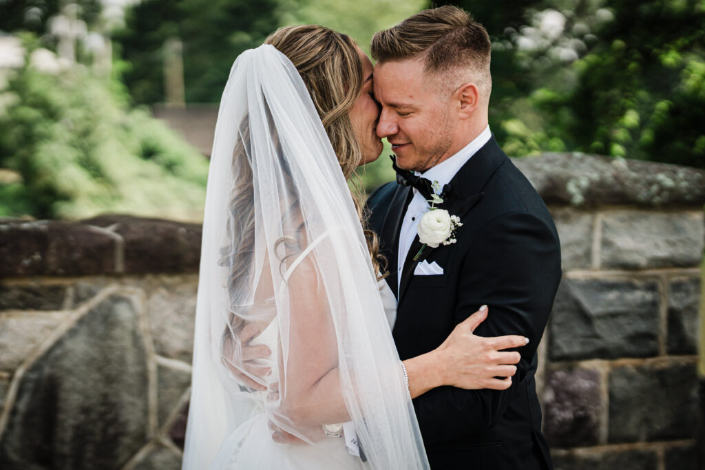 Ilysse and James embracing during their first look at Brooklake Country Club