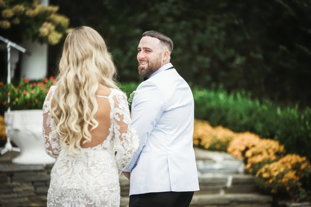 Groom turning to see his bride during a first look at The Legacy Castle in New Jersey