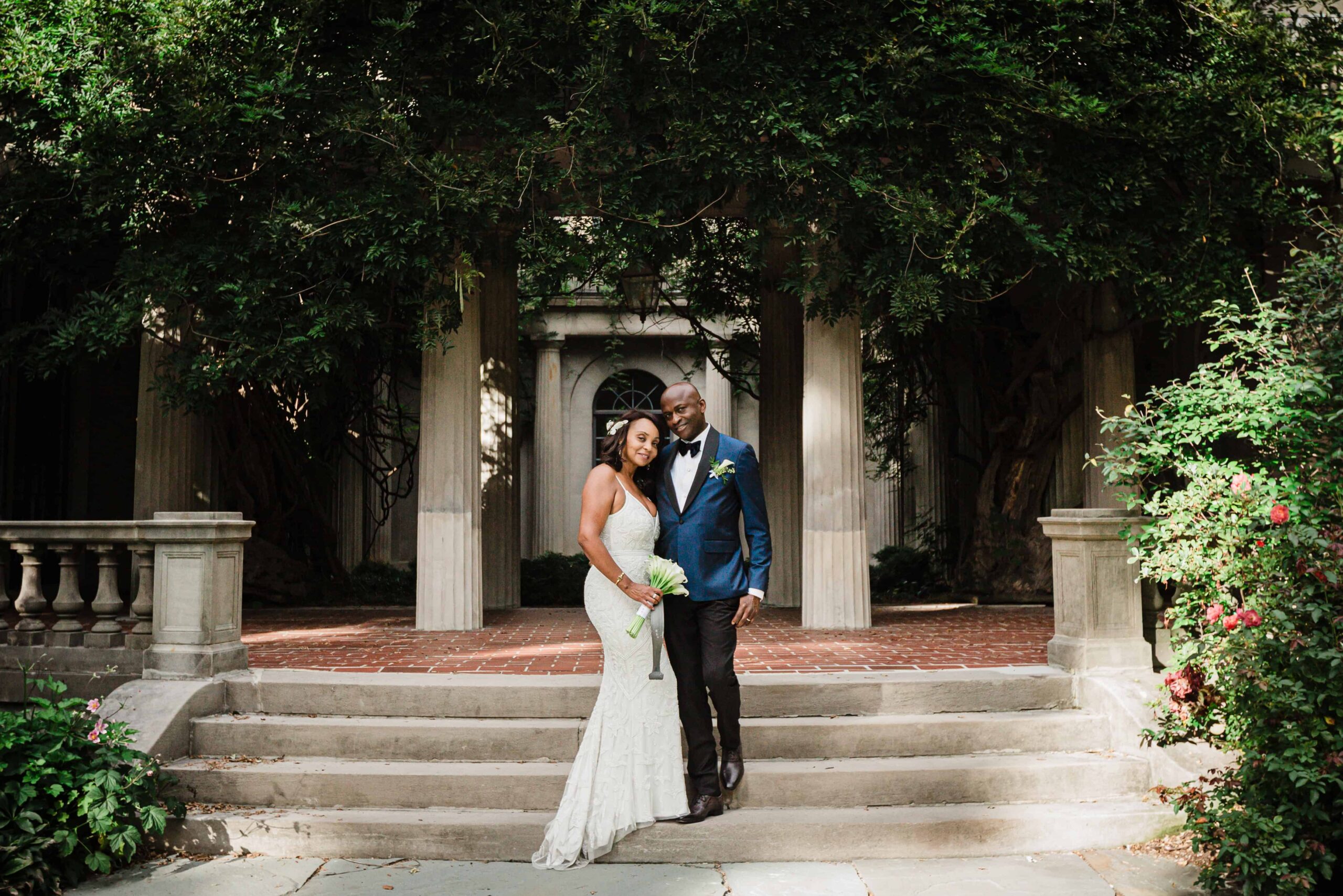 Allison and Pascal standing on the garden steps at Van Vleck House Gardens