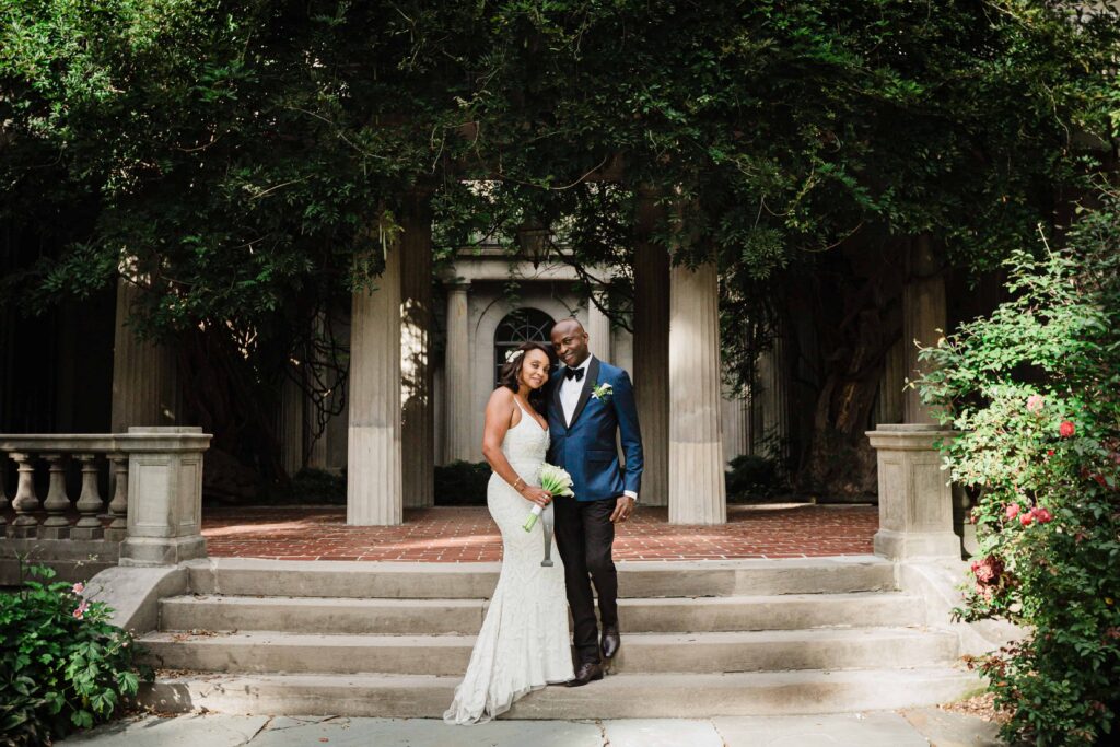 Allison and Pascal standing on the garden steps at Van Vleck House Gardens