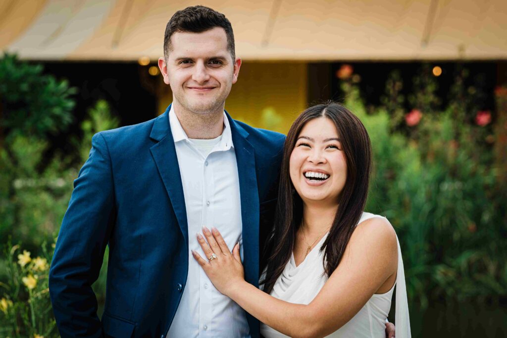 Engaged couple Posing for Close Up Photo with Green Background at Grounds For Sculpture NJ