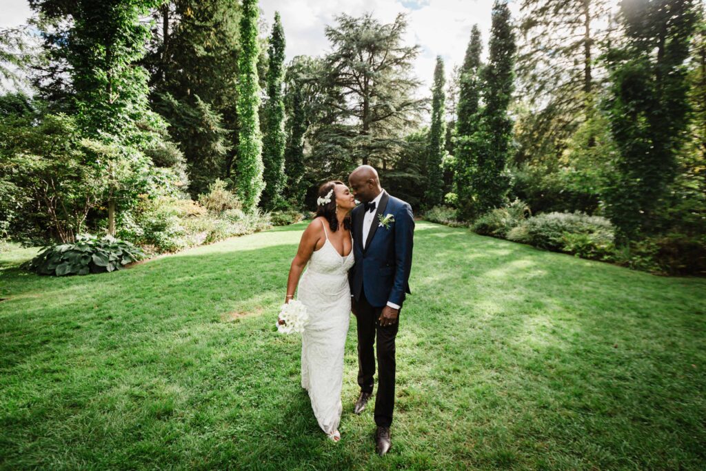 Allison and Pascal leaning together on the lawn at Van Vleck House Gardens