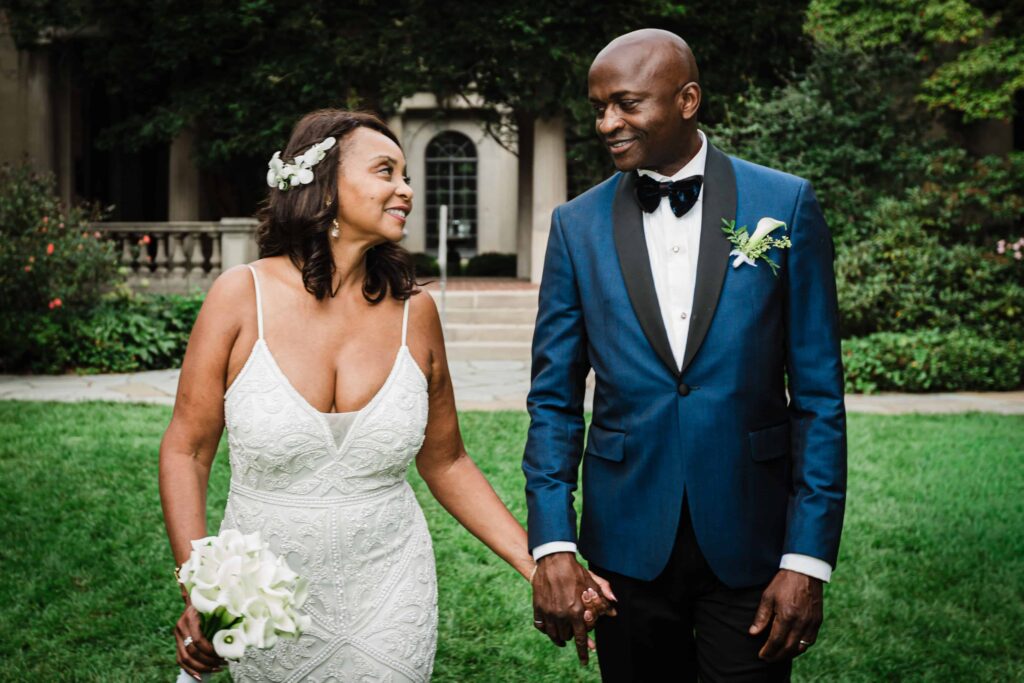 Bride and groom holding hands on the lawn at Van Vleck Gardens Montclair