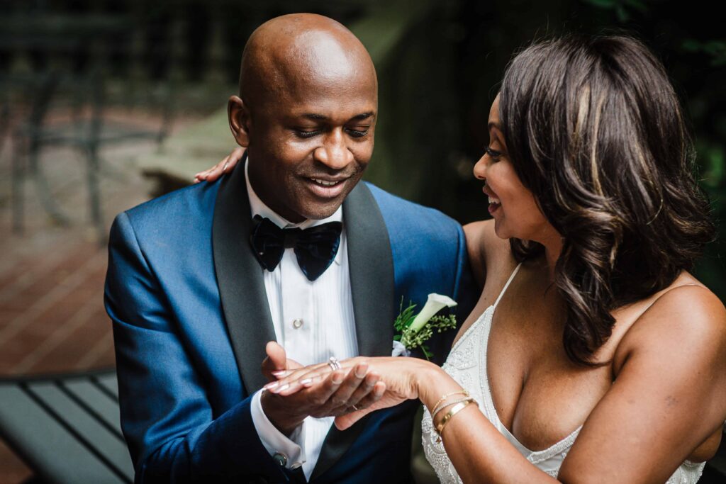 Pascal admiring Allison's wedding ring during portraits at Van Vleck House and Gardens