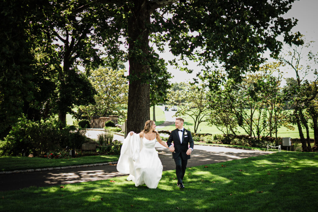 Ilysse and James walking the grounds at their Brooklake Country Club wedding