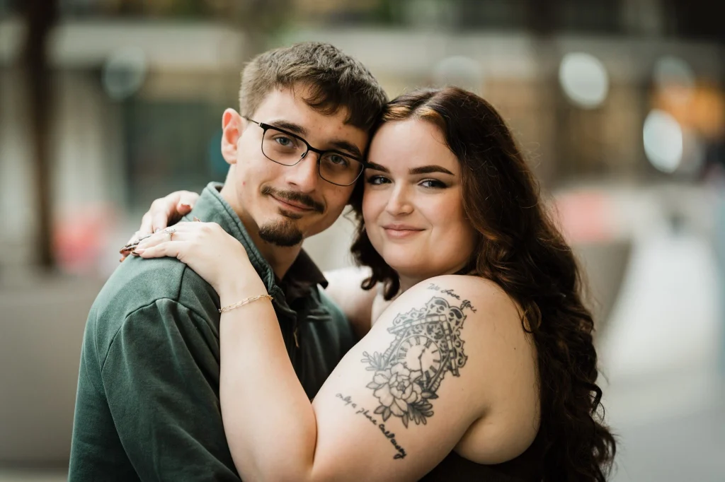Close portrait of an engaged couple resting their heads together at Bell Works