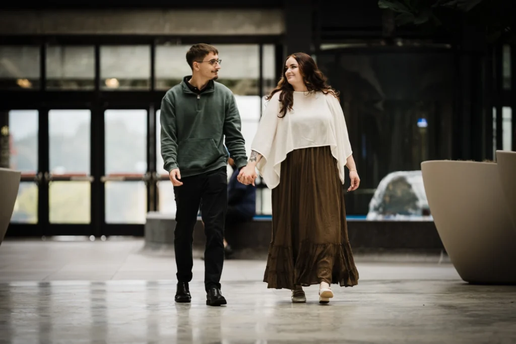 Samuel and Savannah walking hand in hand inside Bell Works during their New Jersey engagement session