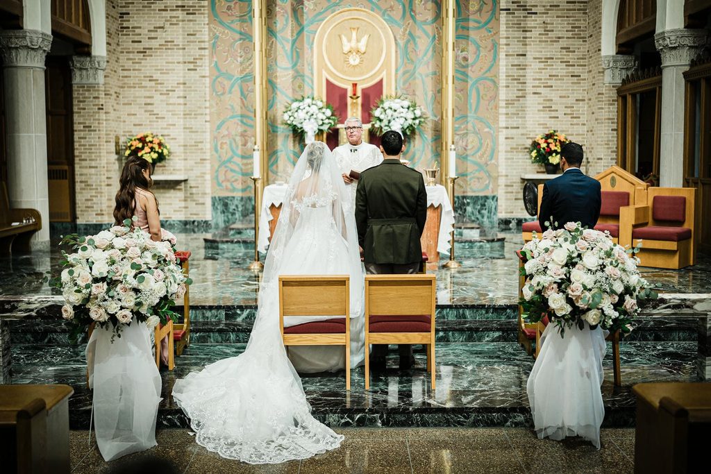 Bride and groom standing at the altar during their St. Gregory the Great Church ceremony